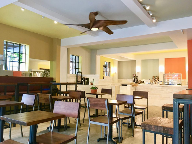 small bright cafe with small wooden tables manhattan ny